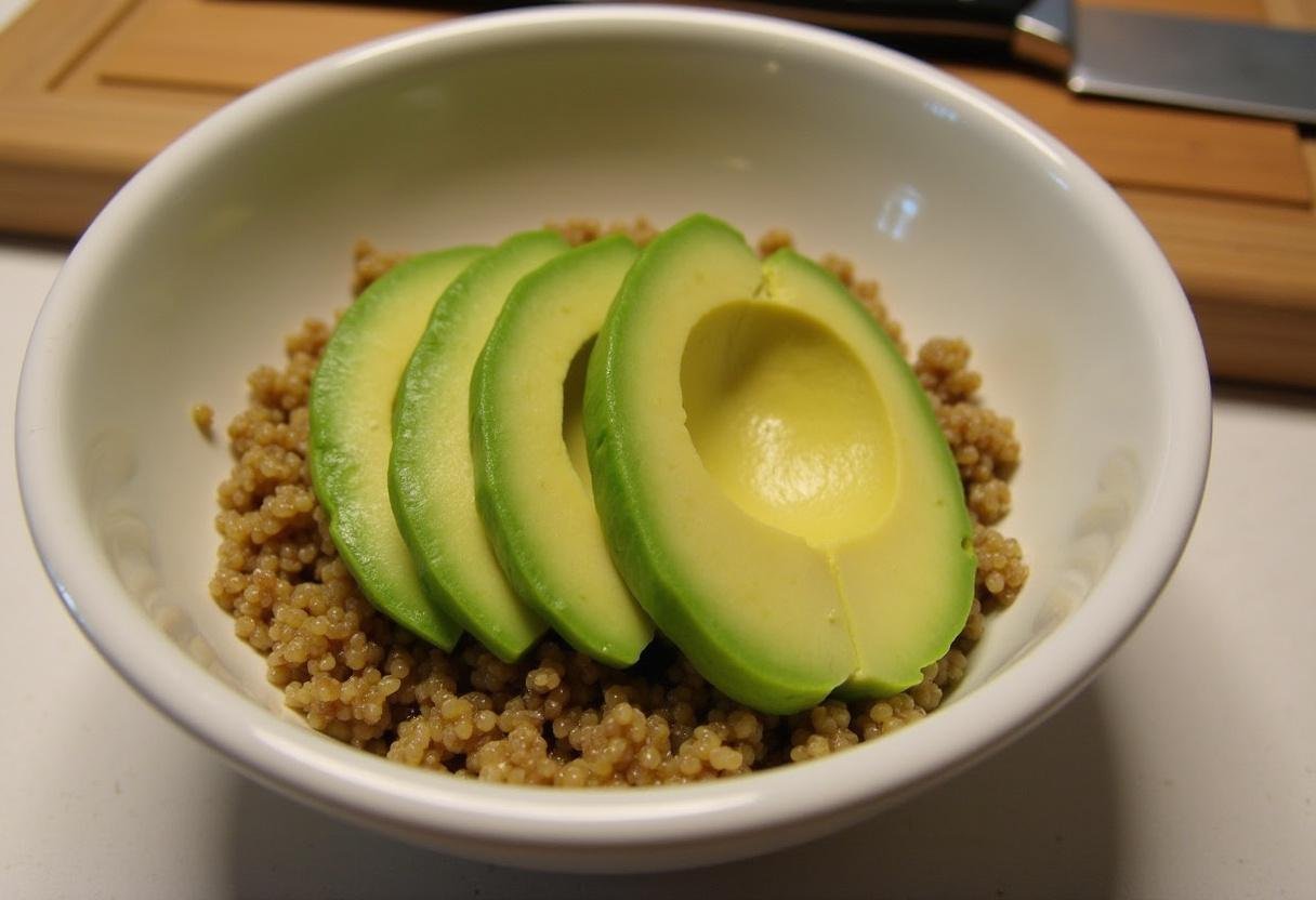 Sliced avocado beautifully placed on quinoa for a nutritious Buddha bowl.
