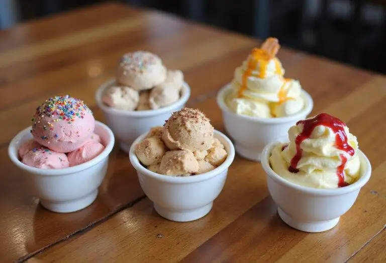 Beautifully presented ice cream cups with rich flavors and toppings, perfect for enjoying on a hot day or for special occasions.