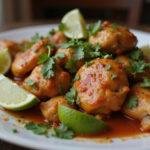 final presentation of chili lime chicken recipe, featuring juicy pieces garnished with lime and herbs for a zesty, tangy treat.