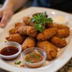 Delicious presentation of addictive crack chicken tenders garnished with herbs and served with rich dipping sauces.