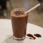 Final presentation of bubbly sweet chocolate pearl sensation, showcasing a delicious chocolate boba drink ready for enjoyment.