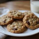 Deliciously baked classic oatmeal craisin cookies displayed on a plate, perfect for enjoying with a glass of milk.