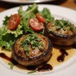 Delicious and visually appealing Grilled Portobello Mushrooms served with a fresh salad and balsamic glaze on a stylish plate.