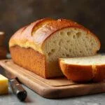 Freshly baked miche bread loaf made with einkorn flour, showcasing its golden crust and soft texture, perfect for serving.